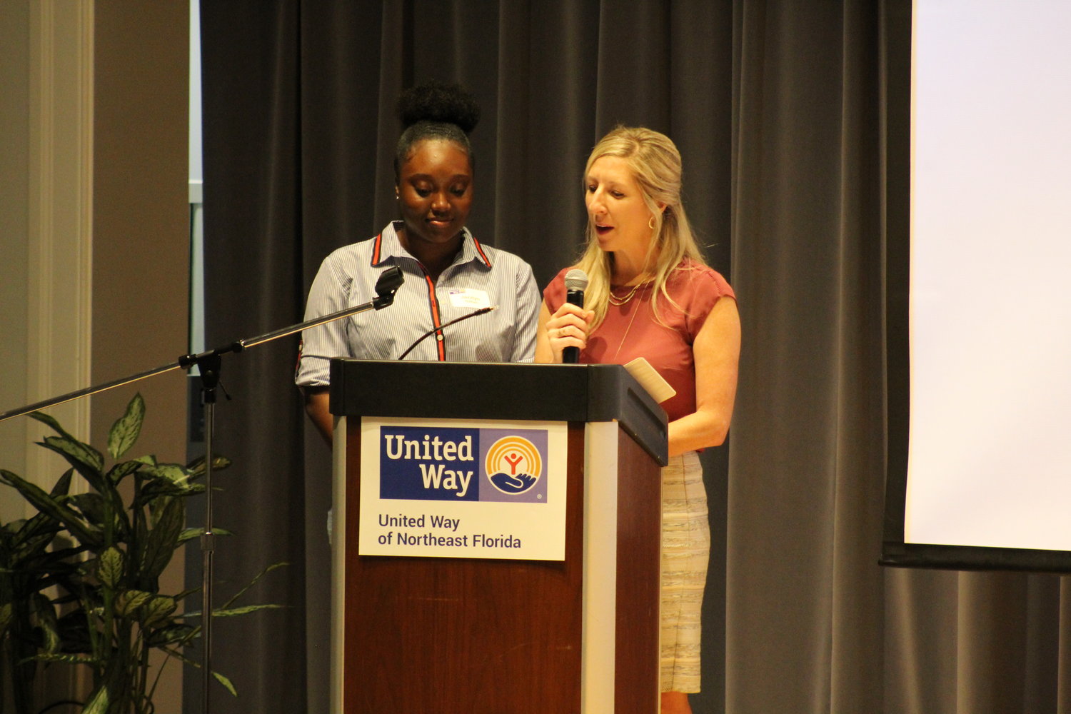 Achiever For Life mentee, Jazzlyn and her mentor Sara McMillan, vice president, Development at The Arc of Jacksonville speak to United Way of Northeast Florida volunteers at the annual Volunteer United celebration.